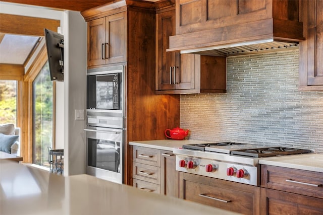 23 Verde Ct, Breckenridge, CO 80424 - kitchen with stainless steel appliances, custom range hood, decorative backsplash, and light countertops