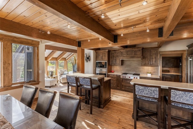 23 Verde Ct, Breckenridge, CO 80424 - kitchen featuring rail lighting, healthy amount of natural light, light wood-style flooring, a kitchen bar, and wood ceiling with exposed beams