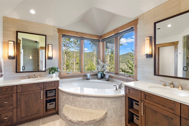23 Verde Ct, Breckenridge, CO 80424 - bathroom featuring two vanities, a garden tub, tasteful backsplash, vaulted ceiling, and recessed lighting