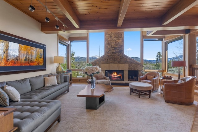 23 Verde Ct, Breckenridge, CO 80424 - living room featuring wooden ceiling with exposed beams, a mountain view, and a stone fireplace