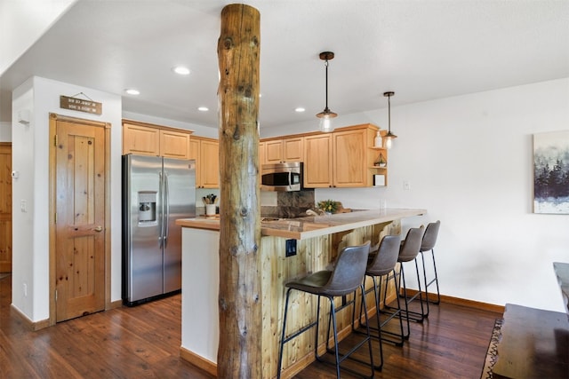 113 Lookout Ridge Dr, Dillon, CO 80435 - kitchen with appliances with stainless steel finishes, dark wood-style flooring, a breakfast bar area, a peninsula, and recessed lighting