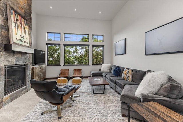 2355 Poma Ln Unit 2355, Steamboat Springs, CO 80487 - carpeted living room featuring a stone fireplace, recessed lighting, and a high ceiling