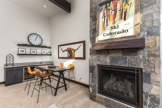 2355 Poma Ln Unit 2355, Steamboat Springs, CO 80487 - dining space with baseboards, beam ceiling, a tile fireplace, light carpet, and an office area