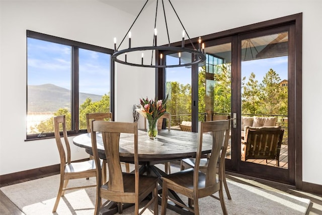 2355 Poma Ln Unit 2355, Steamboat Springs, CO 80487 - dining area featuring a chandelier, baseboards, healthy amount of natural light, and a mountain view