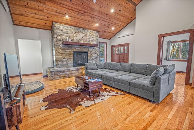 527 E Lincoln Ave, Hayden, CO 81639 - living area with wood ceiling, wood-type flooring, baseboards, high vaulted ceiling, and a stone fireplace