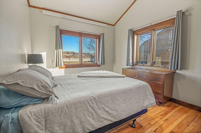 527 E Lincoln Ave, Hayden, CO 81639 - bedroom featuring lofted ceiling, light wood-style floors, multiple windows, baseboards, and crown molding