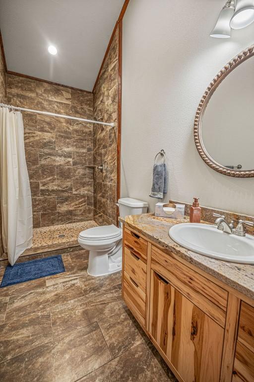 527 E Lincoln Ave, Hayden, CO 81639 - bathroom with toilet, vanity, and a tile shower