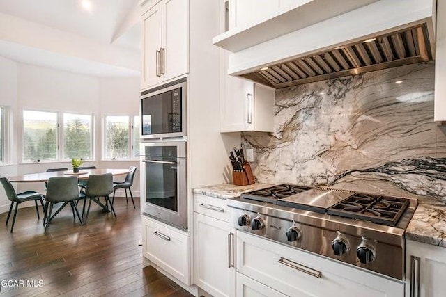 671 Vasquez Rd, Winter Park, CO 80482 - kitchen featuring stainless steel appliances, custom exhaust hood, backsplash, white cabinetry, and dark wood finished floors
