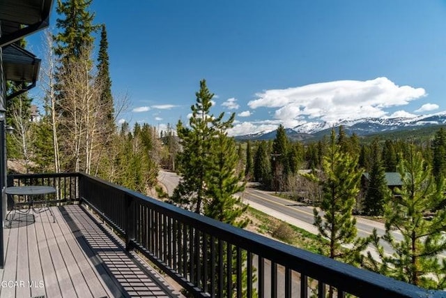 671 Vasquez Rd, Winter Park, CO 80482 - wooden deck with a mountain view and a wooded view