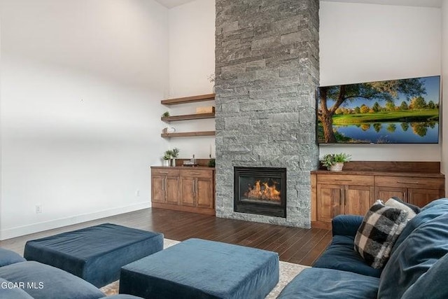 671 Vasquez Rd, Winter Park, CO 80482 - living area with a stone fireplace, dark wood-style flooring, and baseboards