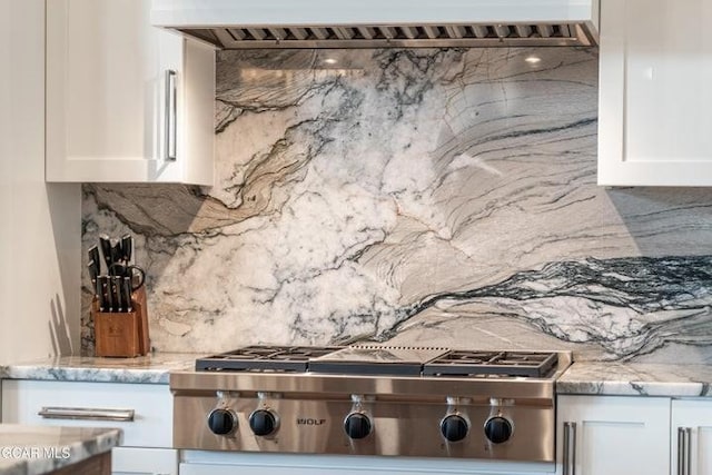 671 Vasquez Rd, Winter Park, CO 80482 - kitchen with stainless steel gas stovetop, tasteful backsplash, range hood, and white cabinets