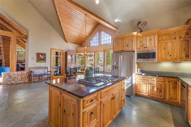 105 Windflower Ln, Frisco, CO 80443 - kitchen with appliances with stainless steel finishes, high vaulted ceiling, a kitchen island, stone tile floors, and dark stone countertops