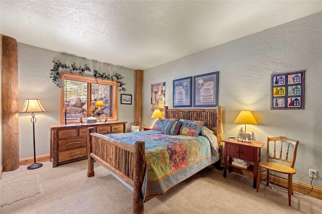 bedroom with light carpet, a textured wall, baseboards, and a textured ceiling