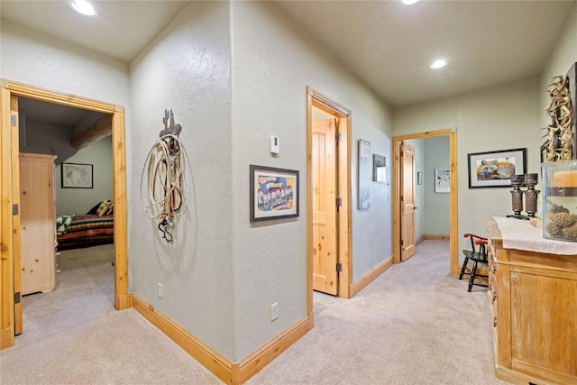 hall with light carpet, recessed lighting, and baseboards