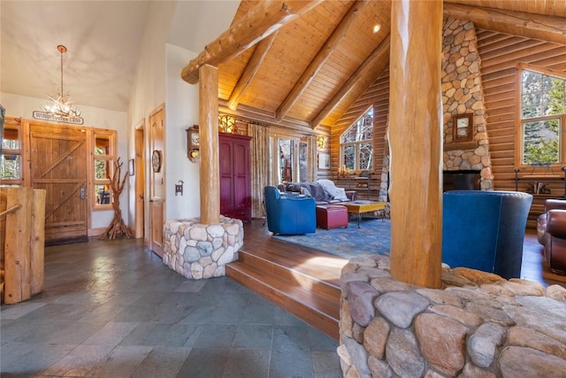 living room with high vaulted ceiling, beam ceiling, wooden ceiling, stone finish floors, and a chandelier