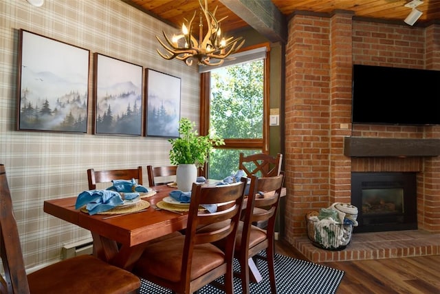 2700 Village Dr Unit D203, Steamboat Springs, CO 80487 - dining area with wood ceiling, wallpapered walls, a chandelier, wood finished floors, and beamed ceiling