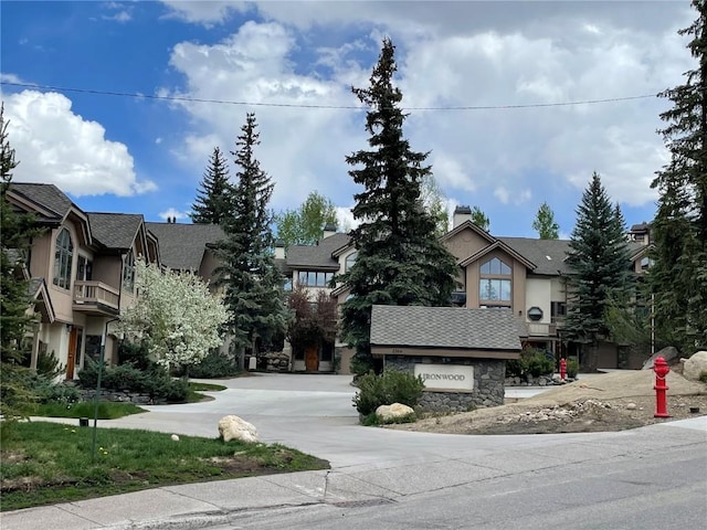 2300 Apres Ski Way Unit 12, Steamboat Springs, CO 80487 - view of front of house with stucco siding, stone siding, a chimney, and a shingled roof