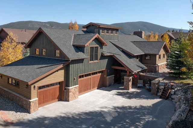 27 Habitat Ct, Dillon, CO 80435 - rustic home with stone siding, board and batten siding, roof with shingles, and a mountain view