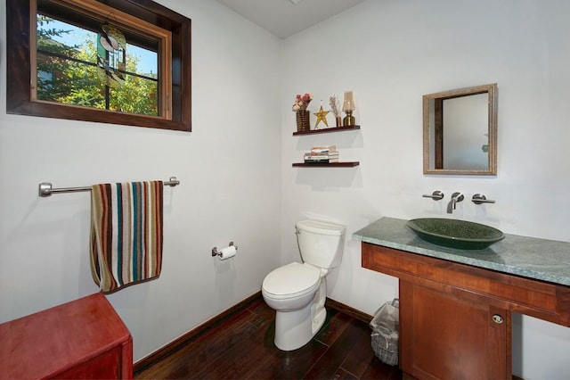 27 Habitat Ct, Dillon, CO 80435 - half bathroom featuring toilet, wood finished floors, vanity, and baseboards