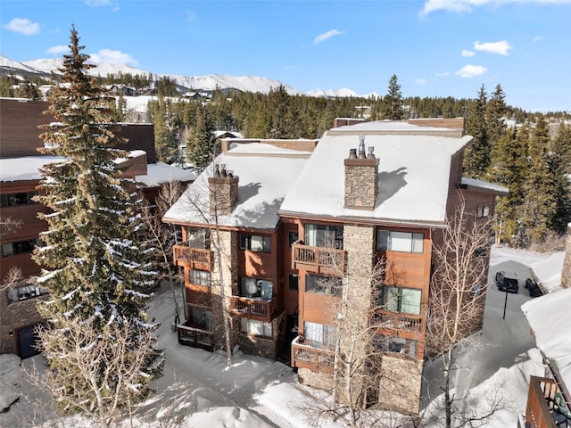 view of snow covered exterior with a mountain view