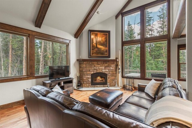 554 Lakeview Dr, Breckenridge, CO 80424 - living area featuring beamed ceiling, wood finished floors, a stone fireplace, baseboards, and high vaulted ceiling