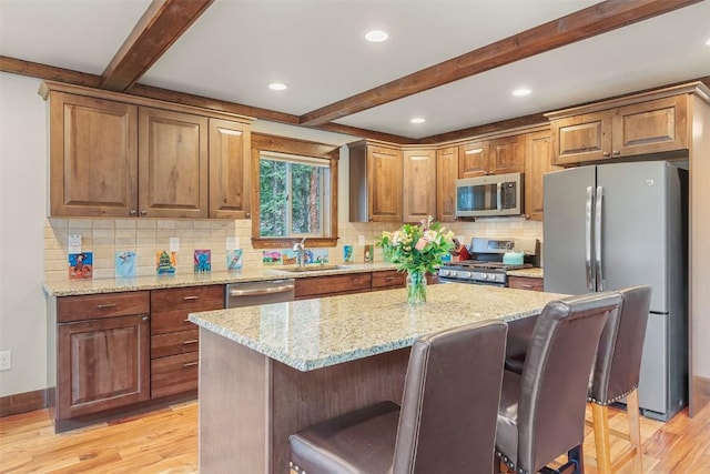 554 Lakeview Dr, Breckenridge, CO 80424 - kitchen featuring appliances with stainless steel finishes, a sink, beamed ceiling, light wood-style floors, and light stone counters