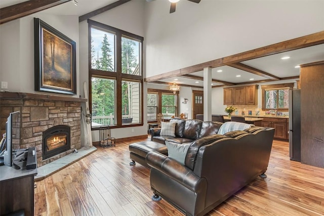 554 Lakeview Dr, Breckenridge, CO 80424 - living room with a fireplace, beamed ceiling, light wood finished floors, plenty of natural light, and a high ceiling