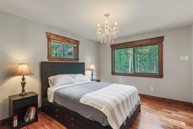 554 Lakeview Dr, Breckenridge, CO 80424 - bedroom with a chandelier, baseboards, and wood finished floors