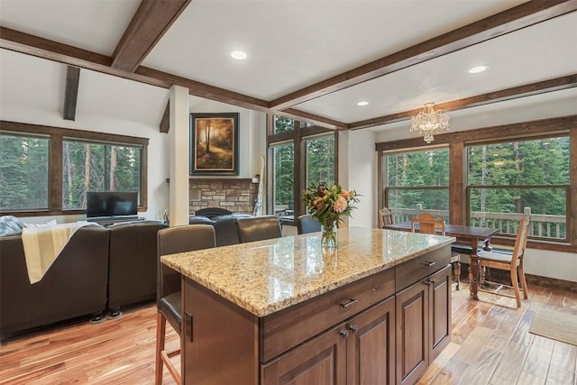 554 Lakeview Dr, Breckenridge, CO 80424 - kitchen with beamed ceiling, open floor plan, light wood-style flooring, light stone counters, and a chandelier
