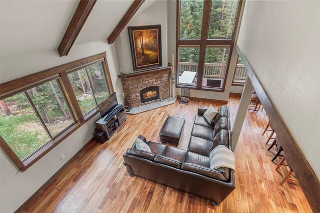 554 Lakeview Dr, Breckenridge, CO 80424 - living room with plenty of natural light, beamed ceiling, wood finished floors, a stone fireplace, and high vaulted ceiling