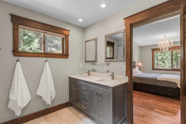 554 Lakeview Dr, Breckenridge, CO 80424 - bathroom with double vanity, baseboards, a chandelier, ensuite bath, and recessed lighting