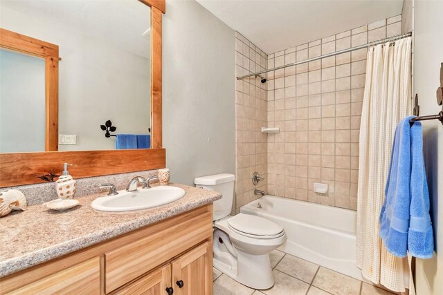 1250 Harwig Cir, Steamboat Springs, CO 80487 - bathroom with tile patterned flooring, toilet, vanity, and shower / bathtub combination with curtain