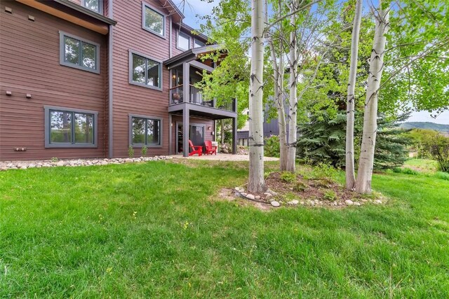 1250 Harwig Cir, Steamboat Springs, CO 80487 - view of green lawn featuring a balcony and a patio area