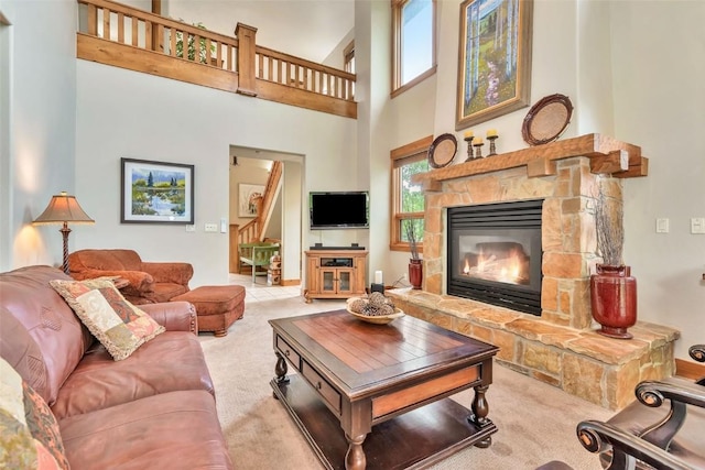 1250 Harwig Cir, Steamboat Springs, CO 80487 - living area featuring carpet, a stone fireplace, a high ceiling, and baseboards