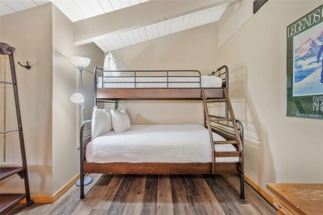 bedroom with wood finished floors, wood ceiling, and baseboards