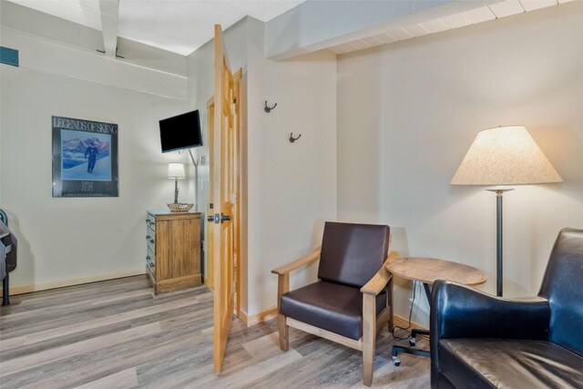 living area featuring wood finished floors and baseboards