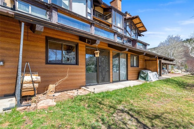 31500 Runaway Pl Unit 308, Steamboat Springs, CO 80487 - back of house featuring a yard and a chimney
