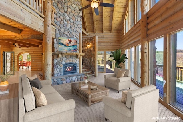380 Darby Dr, Silverthorne, CO 80498 - living area with rustic walls, a ceiling fan, high vaulted ceiling, and beamed ceiling