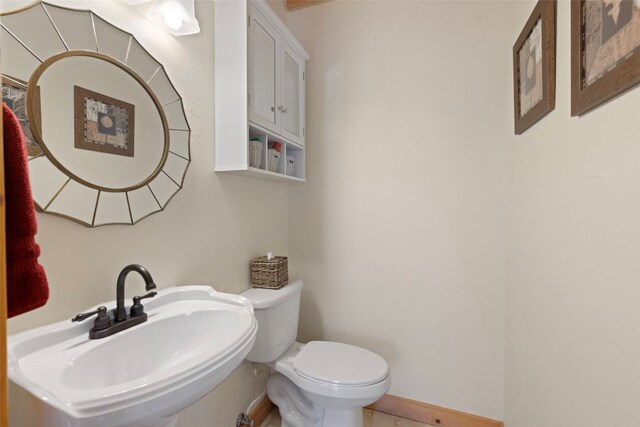 380 Darby Dr, Silverthorne, CO 80498 - half bathroom featuring baseboards, a sink, and toilet
