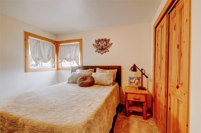 carpeted bedroom with a closet