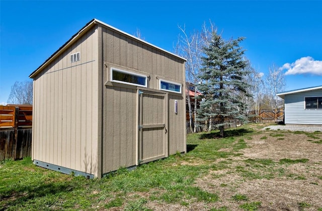 view of shed with fence