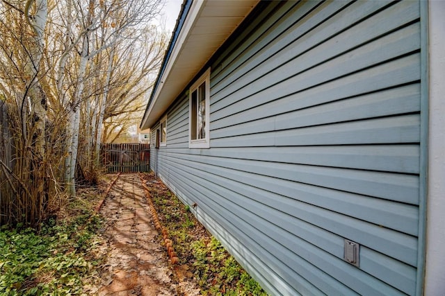 view of side of home featuring fence