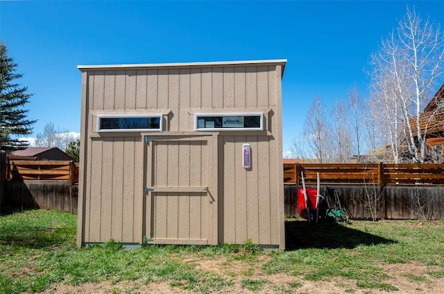 view of shed with fence