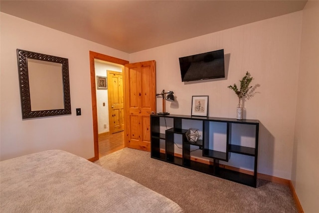 carpeted bedroom featuring baseboards