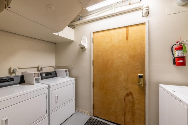 shared laundry area with independent washer and dryer