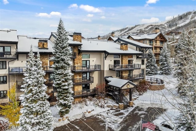 snow covered building with a mountain view