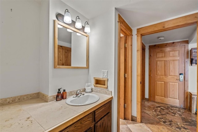bathroom with baseboards and vanity