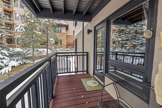 view of snow covered back of property