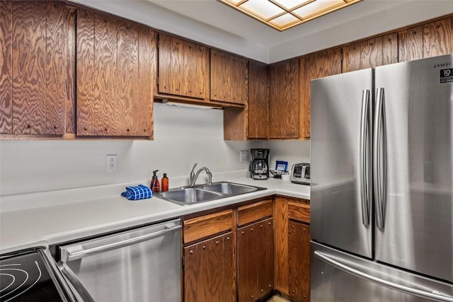 kitchen with light countertops, stainless steel appliances, and a sink