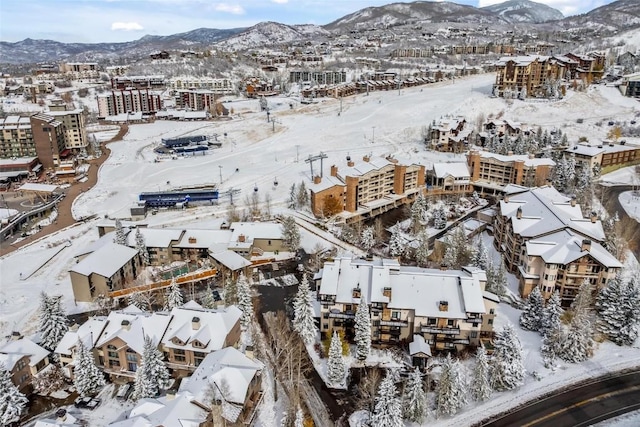 snowy aerial view featuring a mountain view